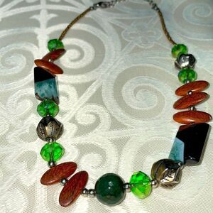 Asymmetrical bead necklace unique beads in green, blue, black, brown, & silver